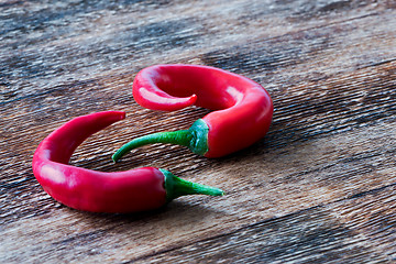 Image showing Chili peppers on wooden background