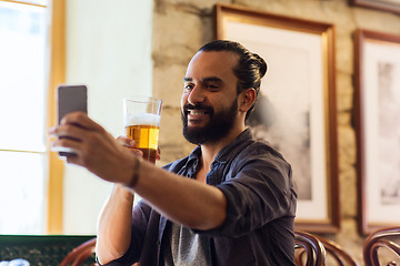 Image showing man with smartphone drinking beer at bar or pub