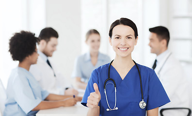 Image showing happy doctor over group of medics at hospital