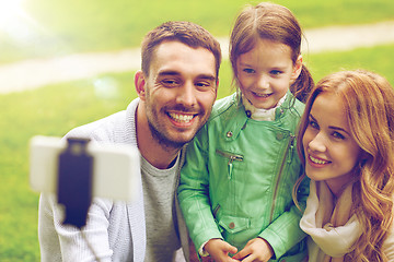 Image showing happy family taking selfie by smartphone outdoors