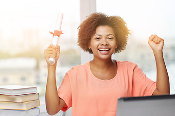 Image showing happy african woman with laptop, books and diploma