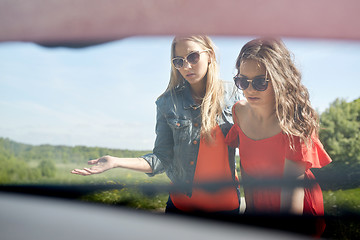 Image showing women with open hood of broken car at countryside