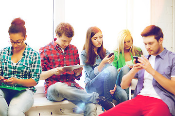 Image showing students looking into devices at school