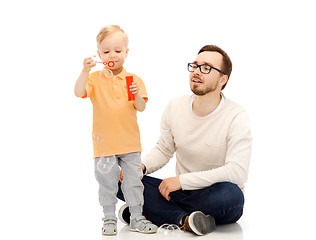 Image showing father with son blowing bubbles and having fun