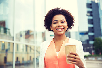 Image showing happy african businesswoman with coffee in city