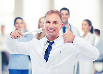 Image showing dentist with toothbrush in hospital