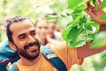 Image showing group of smiling friends with backpacks hiking