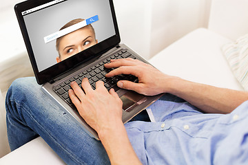 Image showing close up of man typing on laptop computer at home