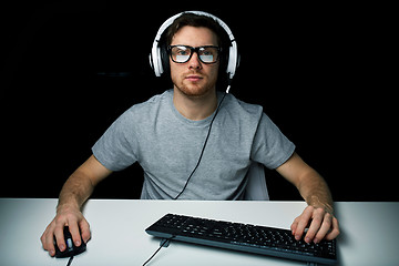 Image showing man in headset playing computer video game