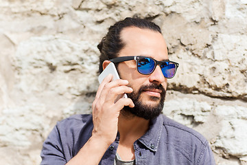 Image showing man with smartphone calling on city street