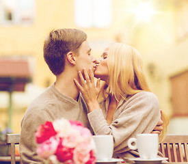 Image showing romantic happy couple kissing in the cafe