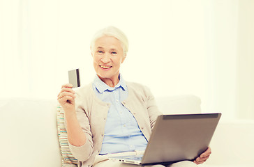 Image showing senior woman with laptop and credit card at home