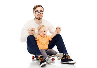 Image showing happy father and little son on skateboard