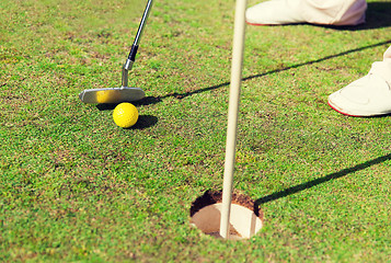 Image showing close up of man with club and ball playing golf