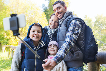 Image showing family with backpacks taking selfie and hiking