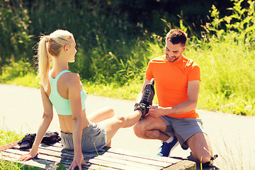 Image showing happy couple with roller skates outdoors