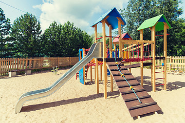 Image showing climbing frame with slide on playground at summer