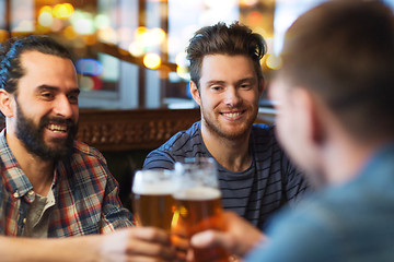 Image showing happy male friends drinking beer at bar or pub