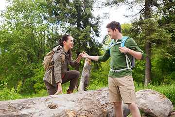 Image showing smiling couple with backpacks hiking