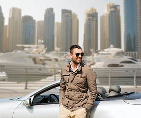 Image showing happy man near cabriolet car on city