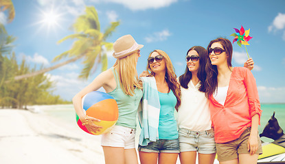 Image showing smiling girls in shades having fun on the beach