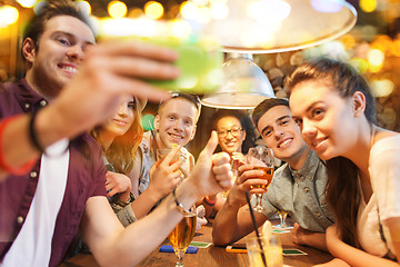Image showing happy friends with smartphone taking selfie at bar