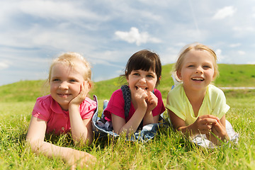 Image showing group of kids lying on blanket or cover outdoors