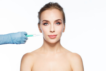 Image showing woman face and hand with syringe making injection