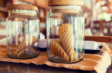 Image showing close up of jars with waffle cones at restaurant