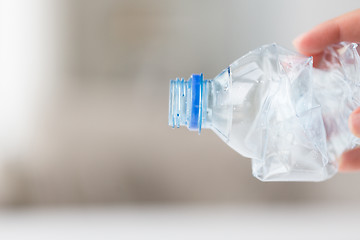 Image showing close up of hand holding used plastic bottle