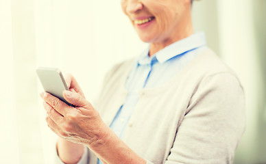 Image showing close up of senior woman with smartphone texting