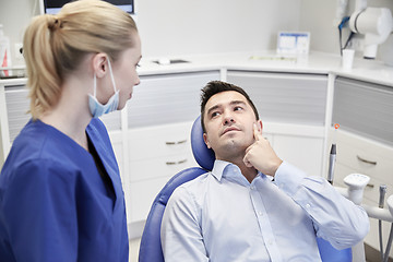 Image showing male dentist with woman patient at clinic