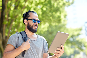 Image showing man traveling with backpack and tablet pc in city