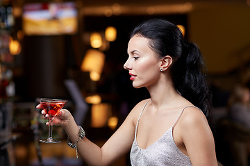 Image showing glamorous woman with cocktail at night club or bar