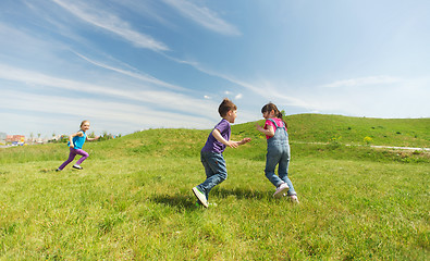 Image showing group of happy kids running outdoors