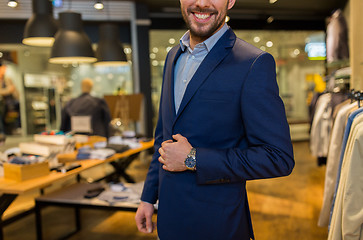 Image showing close up of happy man in suit at clothing store