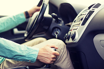 Image showing close up of young man driving car