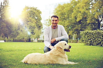 Image showing happy man with labrador dog walking in city