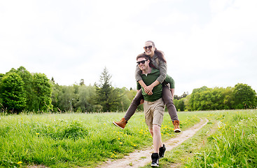 Image showing happy couple with backpacks having fun outdoors