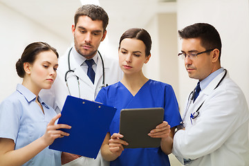 Image showing medics with clipboard and tablet pc at hospital