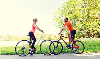 Image showing happy couple riding bicycle outdoors