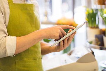 Image showing close up of man with tablet pc at flower shop