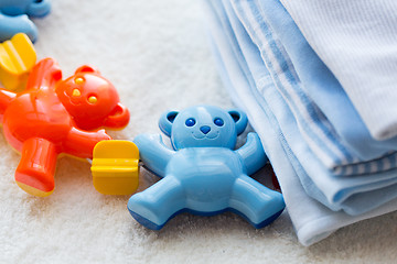 Image showing close up of baby rattle and clothes for newborn