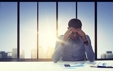 Image showing close up of anxious businessman with papers