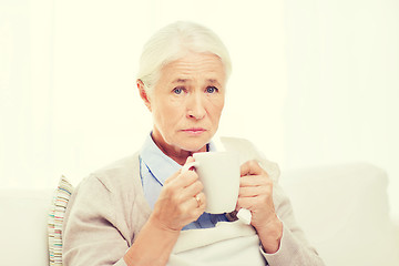 Image showing sick senior woman drinking hot tea at home