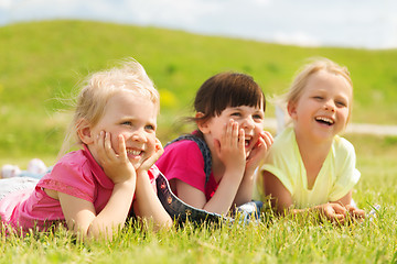 Image showing group of kids lying on blanket or cover outdoors