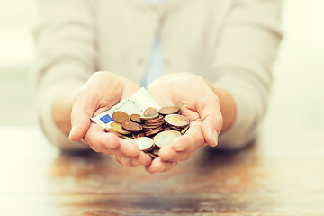 Image showing close up of senior woman hands holding money