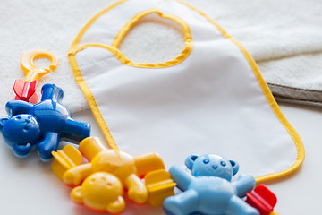 Image showing close up of baby rattle and bib for newborn