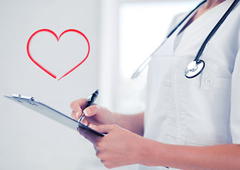 Image showing female doctor with stethoscope and prescription