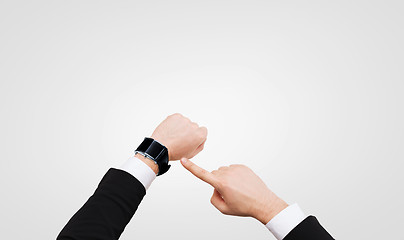 Image showing businessman pointing to smart watch at his hand